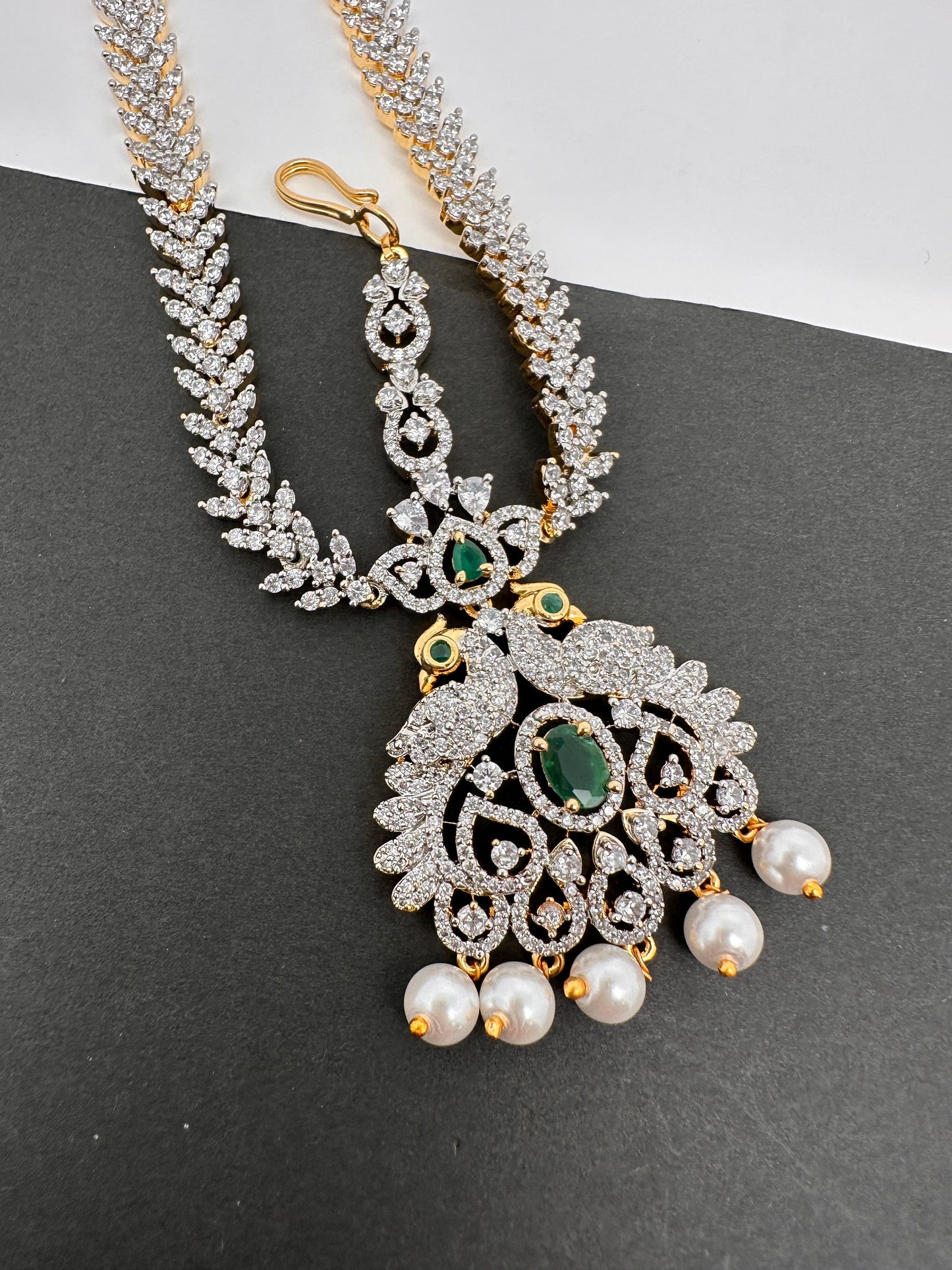 Diamond FinishPeacock Maangteeka Mathapatti with Red Stone