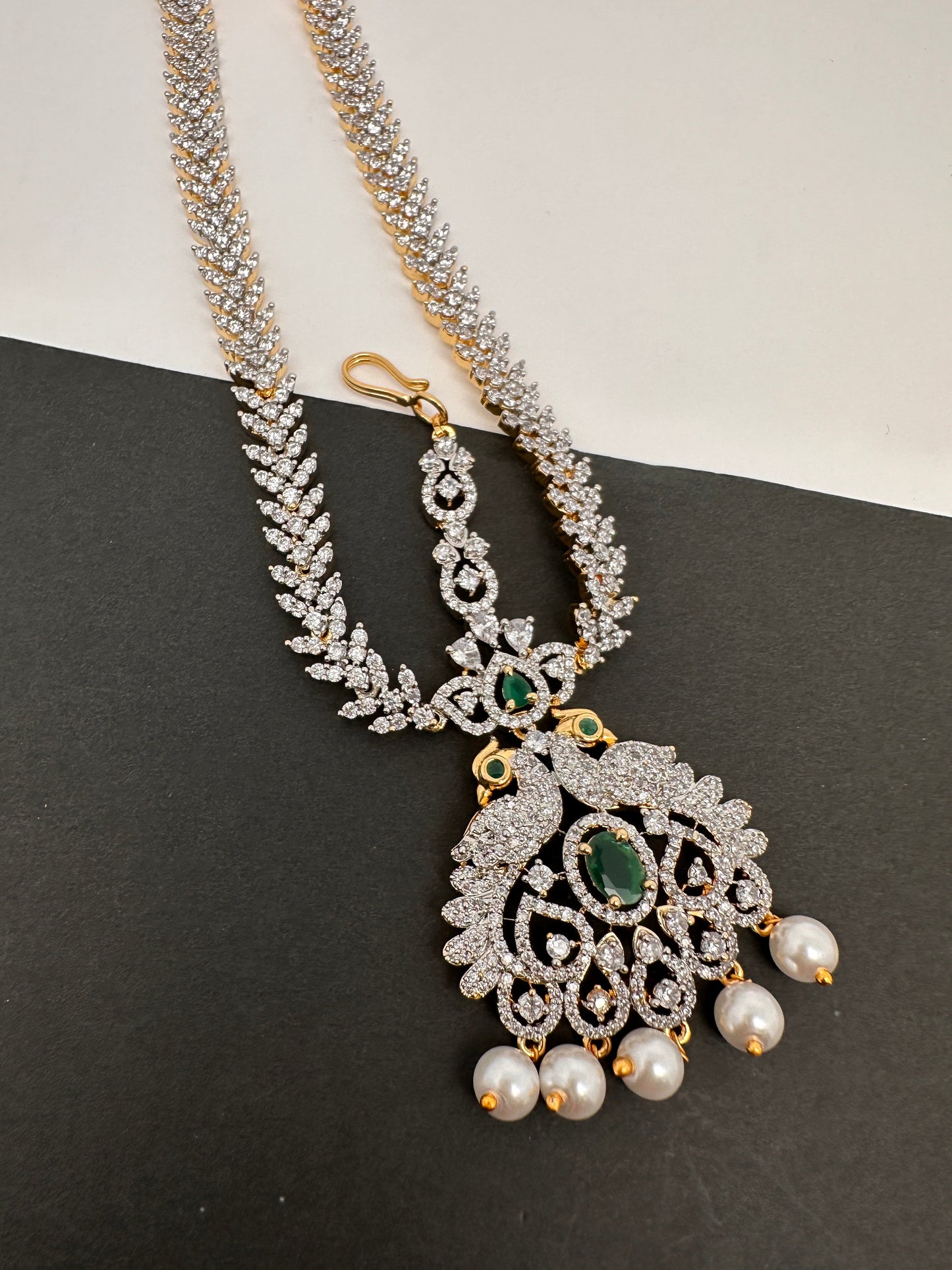 Diamond FinishPeacock Maangteeka Mathapatti with Red Stone