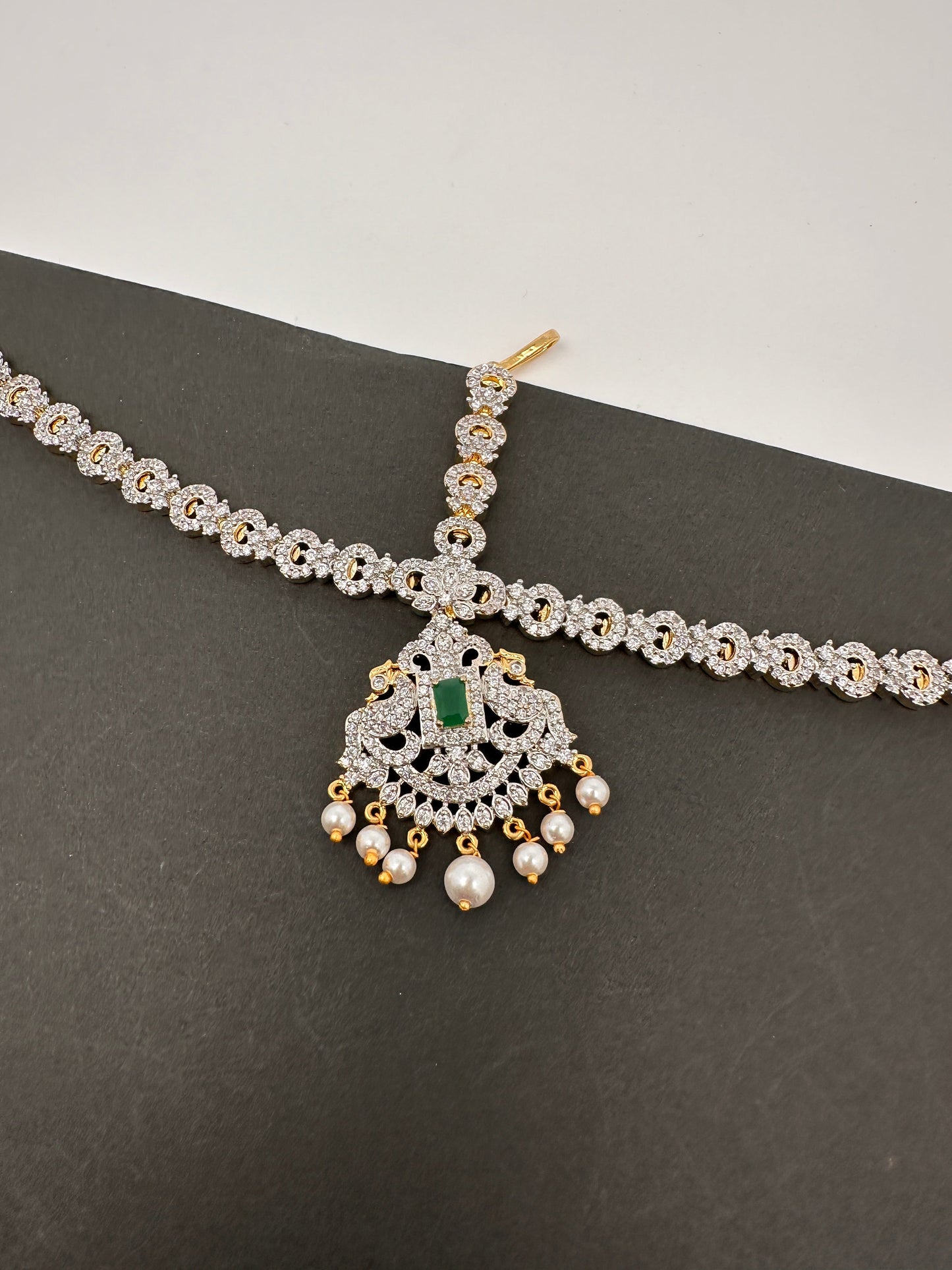 Diamond FinishPeacock Maangteeka Mathapatti with Red Stone